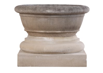 A ROUND CAST STONE PLANTER ON TWO PIECE BASE BY HADDONSTONE.