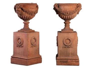 PAIR OF TERRACOTTA PLANTERS HAVING MASK AND SWAG DECORATION RESTING ON SEPARATE PEDESTALS WITH