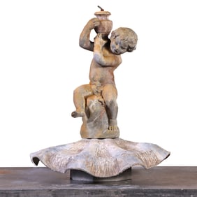 LEAD FOUNTAIN OF A YOUNG MALE HOLDING A JUG ON HIS SHOULDERS RESTING ON A REVERSED CLAM SHELL.