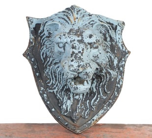 A PAINTED CAST IRON LION FACE WALL PLAQUE.