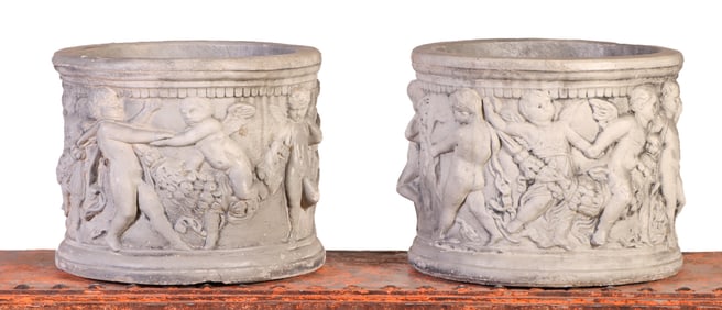 PAIR ROUND CAST STONE PLANTERS WITH FIGURAL DECORATION.