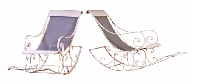 A PAIR OF SLING BACK FRENCH IRON GARDEN ROCKER CHAIRS HAVING SCROLL FORM DESIGN CIRCA 1940.