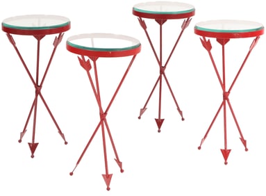 A SET OF FOUR RED IRON AND GLASS DRINKS TABLES HAVING ARROW FORM LEGS.