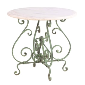 A MARBLE TOP TABLE HAVING ELABORATE WROUGHT IRON BASE.