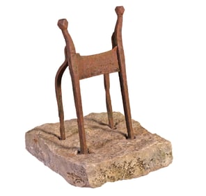 AN ANTIQUE WROUGHT IRON BOOT SCRAPER RAISED ON STONE PLINTH CIRCA 1890.