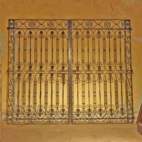 PAIR OF IRON DRIVEWAY GATES WITH STANCHIONS C 1920.