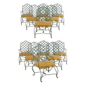 A SET OF TWELVE PAINTED IRON ARM CHAIRS WITH LOOSE SEAT CUSHIONS IN THE STYLE OF GREGORIUS PINEO.