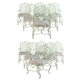 A SET OF TWELVE PAINTED IRON ARM CHAIRS WITH LOOSE SEAT CUSHIONS IN THE STYLE OF GREGORIUS PINEO.