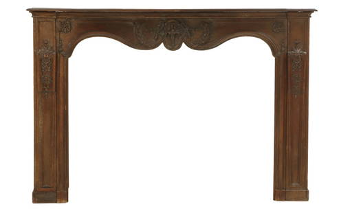 A CARVED OAK 18TH CENTURY FRENCH FIREPLACE MANTLE HAVING SHAPED APRON AND FOLIATE AND FLORAL: A carved oak 18th century French fireplace mantle having shaped apron and foliate and floral decoration. Interior dimensions: Ht: 38", Wd: 51.5" Ht: 48.5" Wd: 72" Dpth: 13"