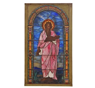 A LARGE ANTIQUE STAINED GLASS WINDOW DEPICTING ST PAUL READING A BOOK.