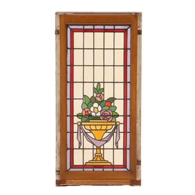 STAINED GLASS PANEL DEPICTING AN URN WITH FLOWERS IN WOOD FRAME C 1910.