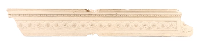 AN ANTIQUE PAINTED PLASTER PEDIMENT HAVING EGG AND DART DECORATION OVER FLORAL ROSETTES.