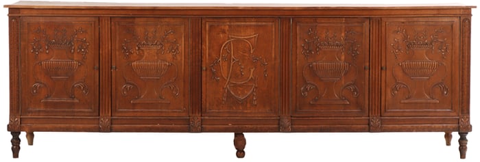 A LARGE CARVED OAK ANTIQUE FRENCH COUNTER OR SERVER HAVING FIVE DOORS WITH URN DECORATION AND