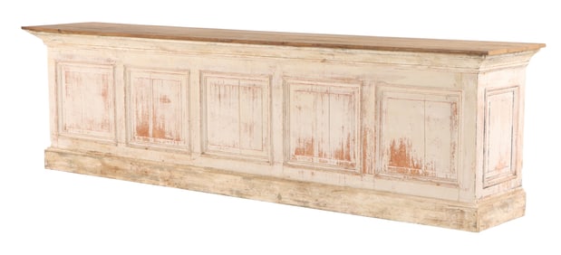 A PARTIAL PAINTED OAK STORE COUNTER HAVING RAISED PANELS ON FRONT AND A DRAWER AND OPEN STORAGE ON
