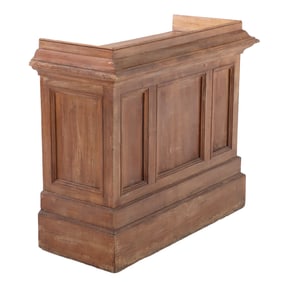 AN ANTIQUE FRENCH RAISED PANEL BAR COUNTER HAVING TOP WITH BACKSPLASH AND AMPLE STORAGE.