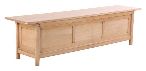A LARGE AND ANTIQUE BIRCH FRENCH COUNTER OR POTTING TABLE HAVING OPEN STORAGE COMPARTMENT.