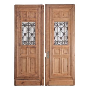 ONE OF TWO PAIRS OF FRENCH CARVED OAK DOORS HAVING RAISED PANELS AND WROUGHT IRON SIGHT PANELS CIRCA