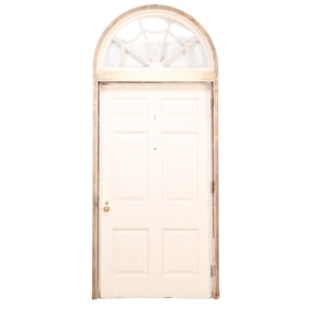 A PAINTED WOOD DOOR HAVING RAISED PANELS WITH SPIDER WEB ARCHED TRANSOM CIRCA 1920.