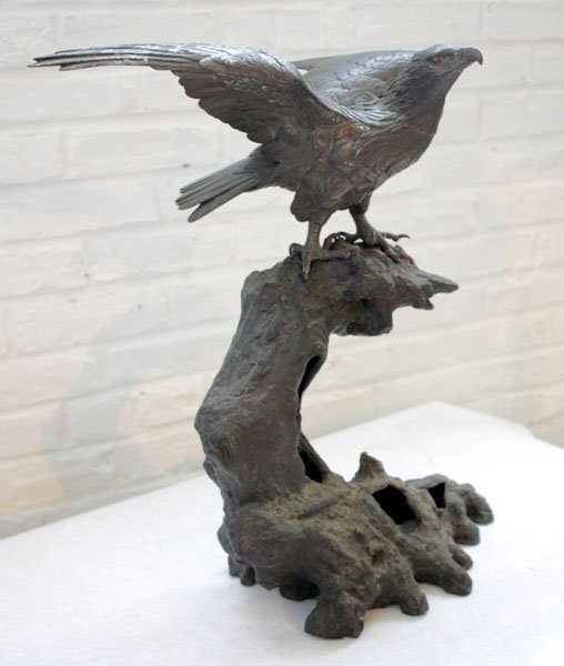 ASIAN BRONZE HAWK FOUNDRY MARK: Finely executed Asian bronze hawk with foundry or maker's mark on underside of tail circa 1900. Resting atop a naturalistic bronze base. Ht: 10" Width: 16" Depth: 14"