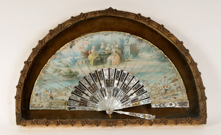 HAND PAINTED FRENCH FAN IN SHADOW BOX CIRCA 1900: A hand painted antique French fan having polychromed mother of pearl ribs in gilt wood shadow box circa 1900. Ht: 15" Width: 23" Depth: 1"