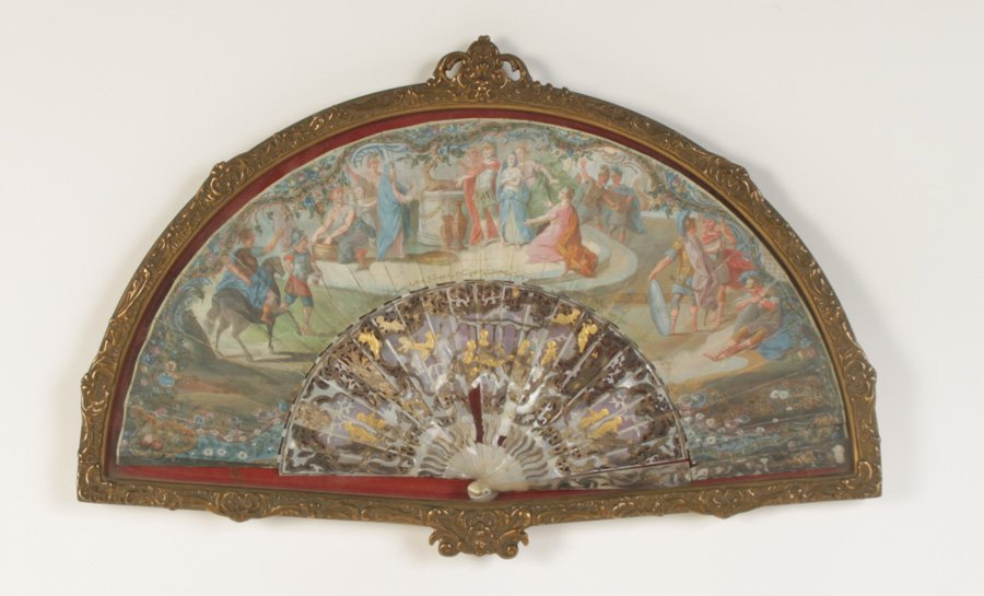 ANTIQUE HANDPAINTED HAND FAN IN SHADOW BOX C.1890: An antique hand painted hand fan featuring a pastoral Roman scene atop mother of pearl ribs in an ornate shadow box circa 1890. Ht: 14" Width: 22" Depth: 1"