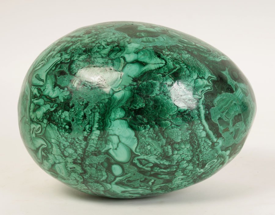 A LARGE MALACHITE EGG DECORATIVE ELEMENT: A large malachite egg decorative element. Ht: 6" Width: 9" Depth: 6"