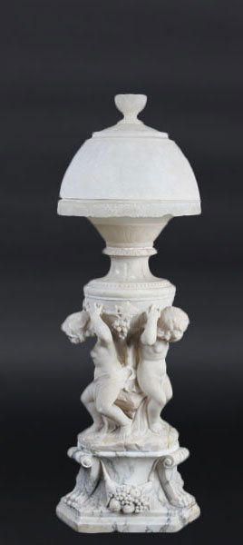 ANTIQUE CARVED ALABASTER LAMP PUTTI C.1900: Wonderfully carved alabaster lamp having three putti holding grape clusters atop lions' paw footed plinth circa 1900. The whole resting on a carved alabaster column base. Ht: 43"