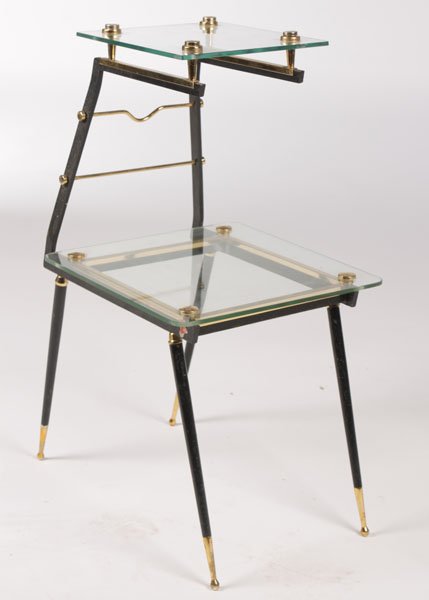 MODERN WROUGHT IRON BRONZE SIDE TABLE: A mid century modern wrought iron and bronze side table having cantilevered form with two tiers of glass shelves circa 1960. Ht: 26.5" Width: 15.5" Depth: 13"