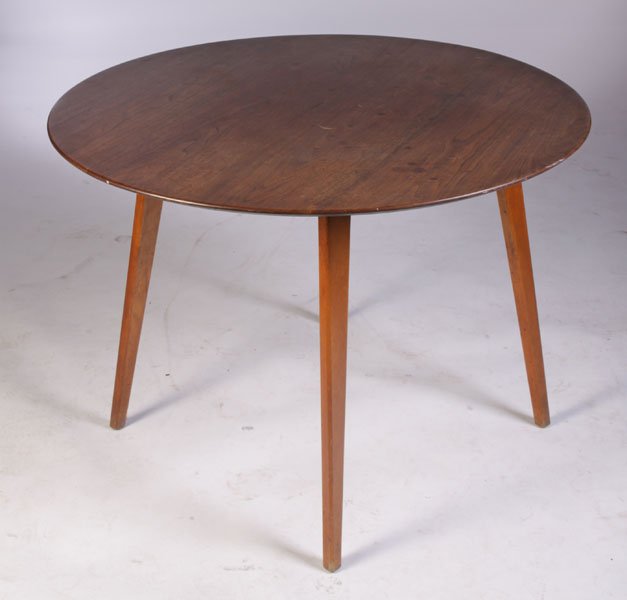 LABELED JENS RISOM ROUND DINING TABLE: A labeled Jens Risom round dining table having a chamfered edge supported on tapered legs circa 1960. Ht: 28.5" Dia: 40"
