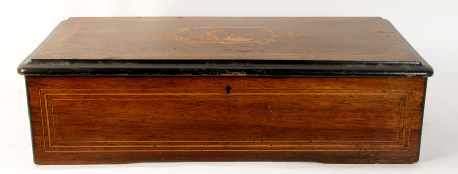 INLAID SWISS MUSIC CYLINDER BOX MARQUETRY TOP: An inlaid Swiss cylinder music box having marquetry top playing eight airs including "When Johnny Comes Marching Home" circa 1880. Ht: 5" Width: 20" Depth: 9"