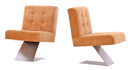 PAIR OF UPHOLSTERED LOUNGE CHAIRS HAVING A STAINLESS STEEL BASE AND NEW FABRIC.