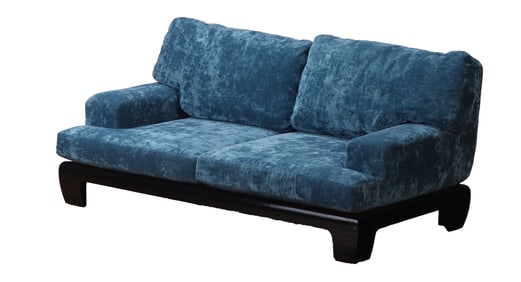 FRENCH BLUE VELVET UPHOLSTERED SOFA HAVING AN EBONIZED WOOD BASE.