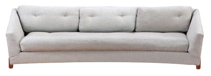 A CURVED LIGHT GREY SOFA IN THE MANNER OF ADRIAN PEARSALL C 1960