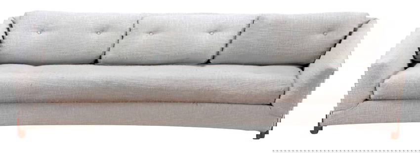 A CURVED LIGHT GREY SOFA IN THE MANNER OF ADRIAN PEARSALL C 1960: A curved light grey sofa in the manner of Adrian Pearsall c 1960 Ht: 25" Wd: 97.5" Dpth: 35.5" Seat: 14"