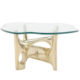 HEAVY BRASS BIOMORPHIC TABLE HAVING A THICK SHAPED GLASS TOP IN THE MANNER OF PHILIPPE HIQUILY