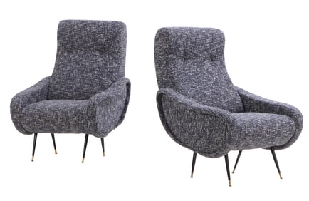 PAIR OF UPHOLSTERED LOUNGE CHAIRS RESTING ON IRON AND BRASS LEGS IN THE MANNER OF MARCO ZANUSO.