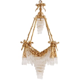 A BELLE EPOQUE STYLE GILT BRONZE AND CUT CRYSTAL CHANDELIER HAVING SWAG DECORATION.