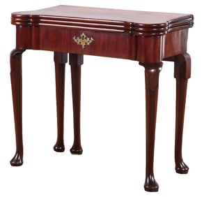 AN EIGHTEENTH CENTURY QUEEN ANNE MAHOGANY DOUBLE FLIP TOP GAMES TABLE.