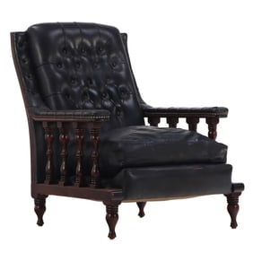 ENGLISH LATE NINETEENTH CENTURY LIBRARY CHAIR WITH SPINDLE SIDES AND BLACK LEATHER UPHOLSTERY.