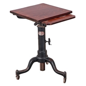 AN IRON AND OAK ADJUSTABLE PEDESTAL WITH PULL OUT SLIDE BY SATELLITE TABLE COMPANY CIRCA 1900.