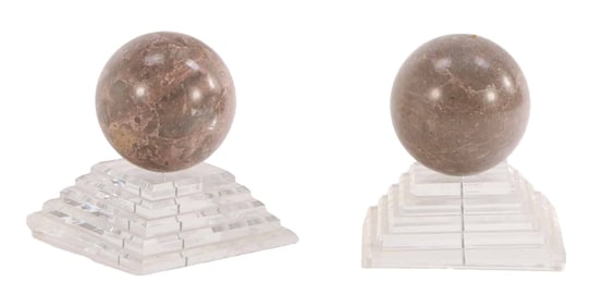 ONE OF TWO PAIR OF POLISHED MARBLE SPHERES MOUNTED ON LUCITE BASES.