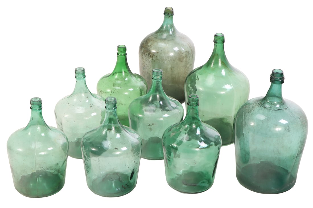 A COLLECTION OF BLUE-GREEN GLASS DEMIJOHN BOTTLES: A collection of blue-green glass demijohn bottles Smaller bottle- Ht: 13", Wd: 7.5", Dpth: 7.5" Ht: 16.5" Wd: 9.5" Dpth: 9.5"