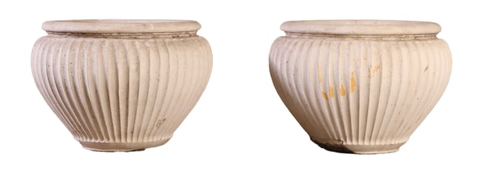 A PAIR OF RIBBED CAST STONE GARDEN PLANTERS.