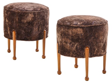 A PAIR OF CIRCULAR FOOT STOOLS HAVING NEW UPHOLSTERY.