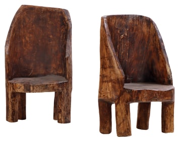 A PAIR OF CARVED WOOD NAGA CHAIRS.
