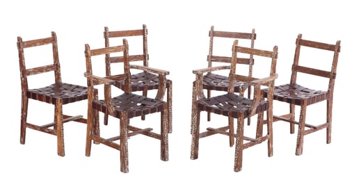 SIX RUSTIC CERUSED OAK AND STRAP WORK LEATHER CHAIRS INCLUDING TWO ARM CHAIRS C 1940.