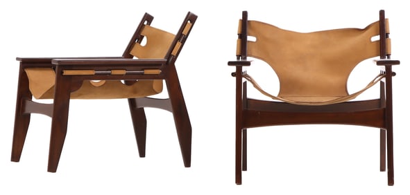 A PAIR OF WALNUT AND LEATHER LOW SLUNG SPANISH CHAIRS IN THE MANNER OF SERGIO RODRIGUES.