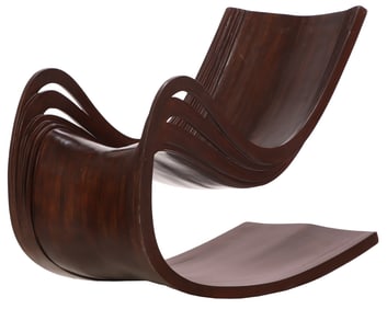 CARVED AND BENTWOOD ROCKING CHAIR WITH NATURALISTIC DESIGN.