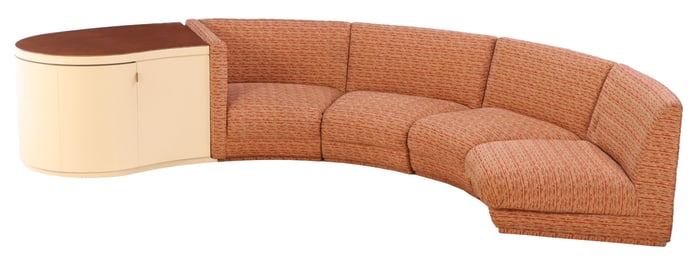 CURVED AND UPHOLSTERED SOFA C 1960 HAVING A PARCHMENT COVERED WOOD BAR CABINET WITH MIRRORED