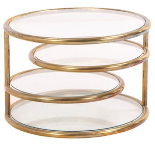 A ROUND BRASS AND GLASS COFFEE TABLE HAVING TWO SWING OUT SHELVES C 1970.